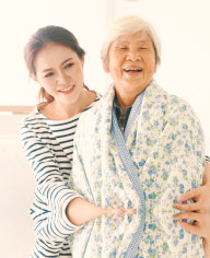 happy elder woman and her caregiver